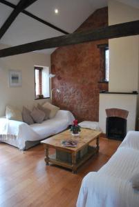 a living room with a couch and a coffee table at Barn conversion near the coast in Paignton