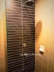 a shower stall in a bathroom with a roll of toilet paper at My Dallyne's Residence at Tamu Hotel & Suites, Kuala Lumpur in Kuala Lumpur