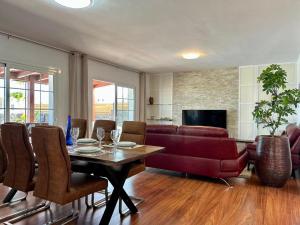 a living room with a table and a couch at Villa Pol Lanzarote in Puerto Calero