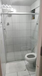 a white bathroom with a toilet and a shower at Boa Vista in Recife