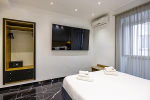 a hotel room with two beds and a large mirror at Hotel Bella Napoli in Naples