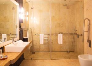 a bathroom with a shower and a sink at Cascade Wellness Resort in Lagos