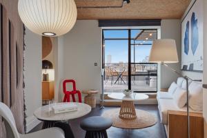 a living room with a couch and a table at One Hundred Shoreditch in London