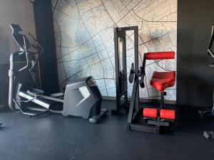 a gym with exercise equipment and a wall at Warsaw Home Suites in Warsaw