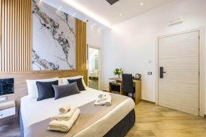 a bedroom with a large bed with towels on it at Hotel Bella Napoli in Naples +195 photos