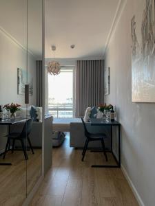 a living room with a dining table and a bed at Warsaw Home Suites in Warsaw