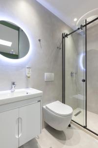 a bathroom with a toilet and a sink and a shower at UrbanBllok5 in Tirana