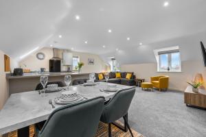 a dining room and living room with a table and chairs at Luxury Apartment in Stockton, sleeps 4, Free WIFI 