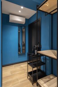 a room with a blue wall and bunk beds at UrbanBllok5 in Tirana