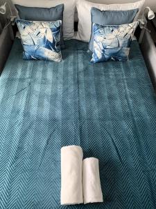 a bed with two pillows on top of it at Warsaw Home Suites in Warsaw