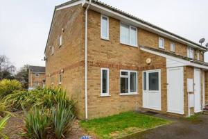 a brick house with white doors in a yard at Ellan Hay by StayStaycations in Bristol