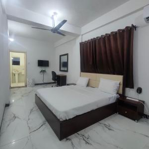 a bedroom with a bed and a ceiling fan at SPIRIT OF INDIA in Lagos
