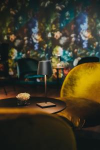 a small lamp on a table in a living room at Boutique Hotel Atrium München in Munich