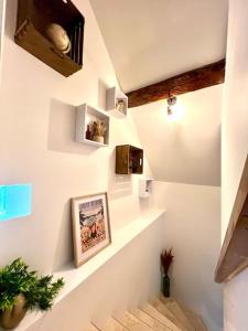 a staircase in a room with white walls at Le Nid Arrivé autonome clim wifi linge inclus in Romorantin