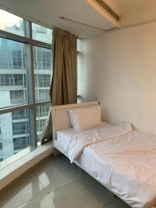 a bed in a room with a large window at ThePenthouse Coliving I in Dubai