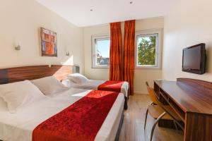 En eller flere senge i et værelse på Hôtel Icare