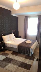 a bedroom with a large bed with a window at Hotel Residence in Istanbul