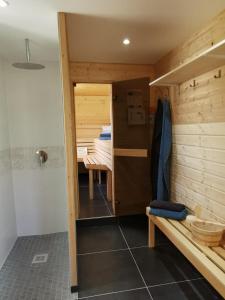 a room with a sauna with a bench and a table at Ferienlandhaus Ahorntal in Ahortal