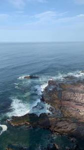 an aerial view of a rocky island in the ocean at Apartamento en Iquique. in Iquique