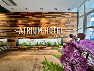 an autumn hotel lobby with purple flowers at Boutique Hotel Atrium München in Munich