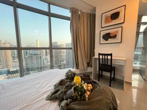 a bedroom with a bed with a view of a city at ThePenthouse Coliving I in Dubai