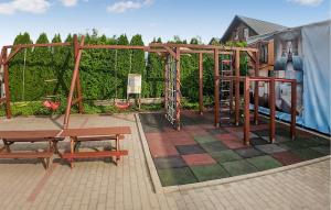 a playground with two benches and a swing at Cozy Home In Rewal With Wi-fi in Rewal