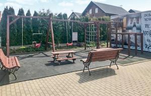 a park with two benches and a swing at Cozy Home In Rewal With Wi-Fi in Rewal