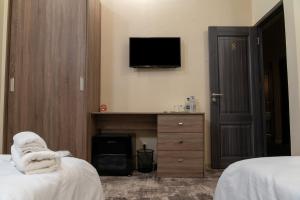 Voodi või voodid majutusasutuse Aeka hotel toas