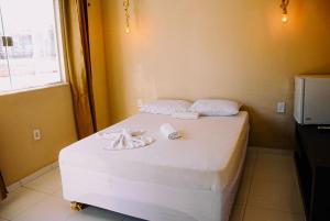 Ένα ή περισσότερα κρεβάτια σε δωμάτιο στο Pousada do gaúcho