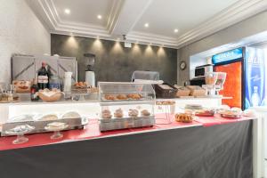 a bakery counter with various pastries on display at Hotel Bella Napoli in Naples