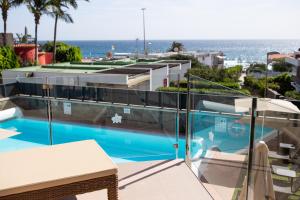 a swimming pool on the roof of a building at La Cataleya in San Agustin