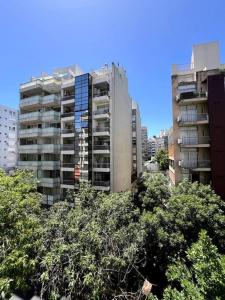 a tall apartment building with trees in front of it at 1 BR *Palermo* Moderno dos ambientes / Zona UP in Buenos Aires