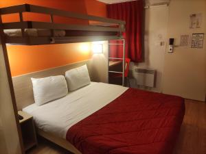a bed in a hotel room with a bunk bed at Premiere Classe Vannes in Vannes