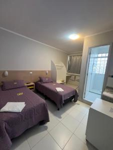 Voodi või voodid majutusasutuse Pousada das Dunas Via Praia Apart Hotel toas