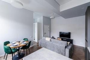 a living room with a couch and a table at Modern flat in Old Town Kaunas - Free Parking & Self Check-In in Kaunas