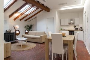 a kitchen and living room with a table and chairs at Matteotti Gallery Venice Apt in Mestre