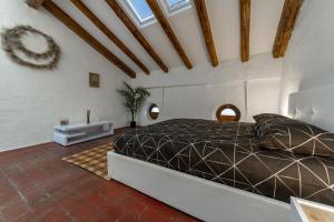 a bedroom with a bed with a black comforter at Matteotti Gallery Venice Apt in Mestre