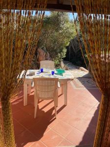 a table and a chair sitting on a patio at Blue Sardinia house in Rena Majore