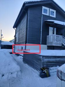 een bord voor een huis in de sneeuw bij Feelhome Borgtun One bedroom cozy apartment in Tromsø