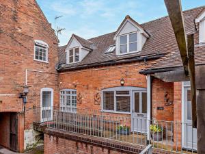 a brick house with white windows and a balcony at 2 Bed in Warwick 93085 in Warwick