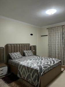 a bedroom with a bed and a television in it at 3 bedrooms flat,fully equipped in Cairo