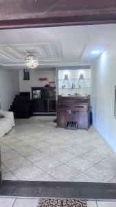 una sala de estar con un piano en una habitación en Do Maraja en Búzios