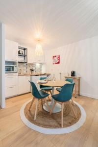 a kitchen with a table and chairs in a room at One bedroom apartment with parking & terrace in Croix +15 photos