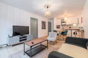 a living room with a couch and a tv at One bedroom apartment with parking & terrace in Croix