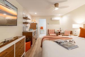 a bedroom with a bed and a living room at The Beach Club on Madison Avenue in Cape May