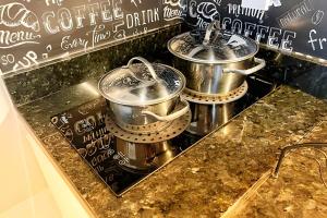 a trio of pots and pans on a counter at The Birthplace of Samba Carioca in Rio de Janeiro