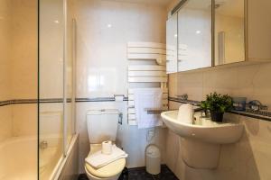 a bathroom with a toilet and a sink and a shower at LA MALMAISON AP1064 Villefranche-sur-Mer, by RIVIERA HOLIDAY HOMES in Villefranche-sur-Mer +22 photos
