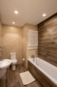 a bathroom with a tub and a toilet and a sink at Four Seasons Apartment 9 in St. Paul's Bay