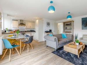 a living room and kitchen with a couch and a table at 2 bed in Caernarfon 86260 in Y Felinheli