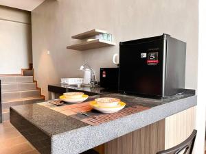a kitchen with a counter with two bowls on it at HillLand Suites in Ayer Keroh